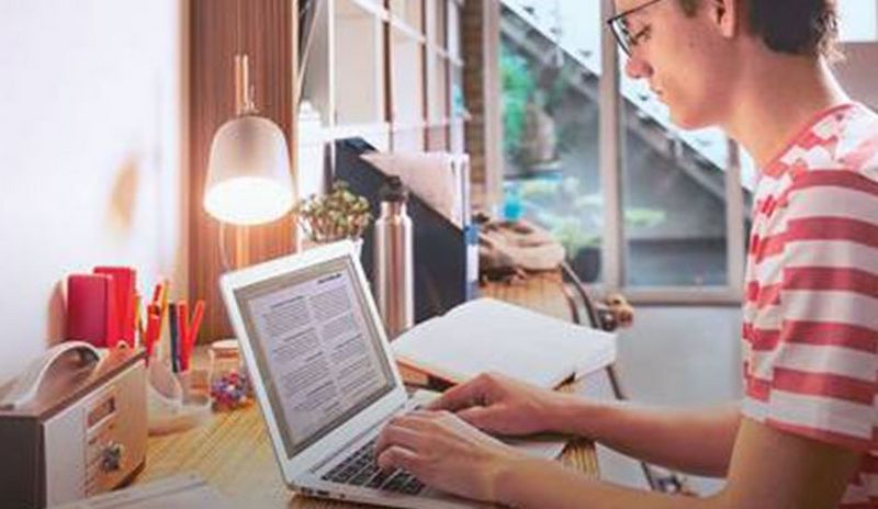 Student sitting by his laptop