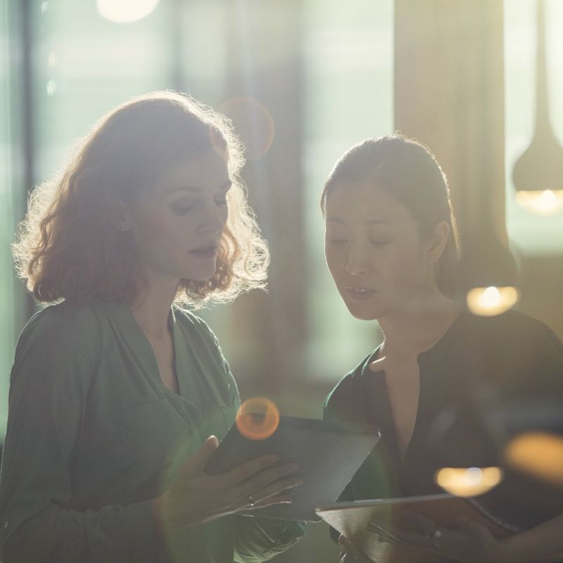 Two females looking over an iPad