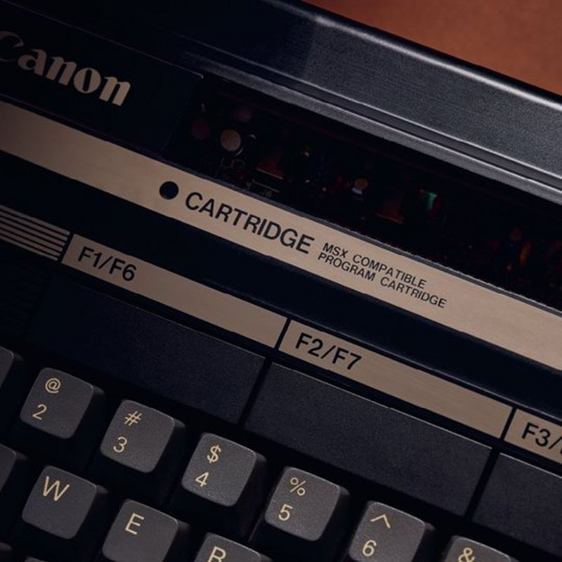 A close up of the Canon V-20 home computer, showing the Canon logo, the text ‘CARTRIDGE MSX COMPATIBLE PROGRAM CARTRIDGE’ and F keys.