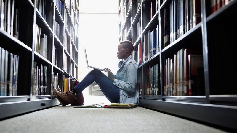 Woman on floor in library 