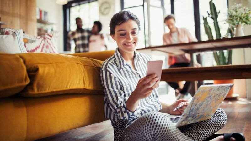 Young woman smiling on laptop 