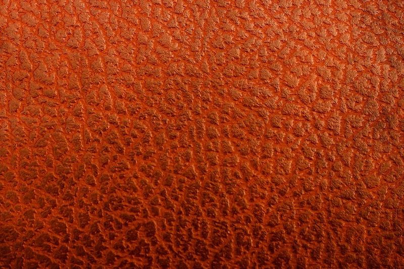 Comparison slider of two image of the same brown leather shoe. The right side shows a close-up of perforated detail.