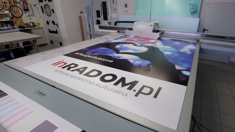 Employees of Sign Production checking retail prints