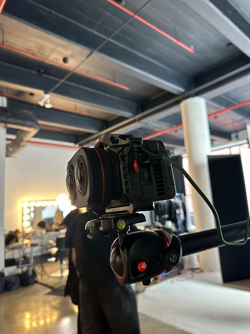 A behind the scenes image of the Canon EOS R5 C on a tripod, with the RF 5.2mm F2.8L lens attached.