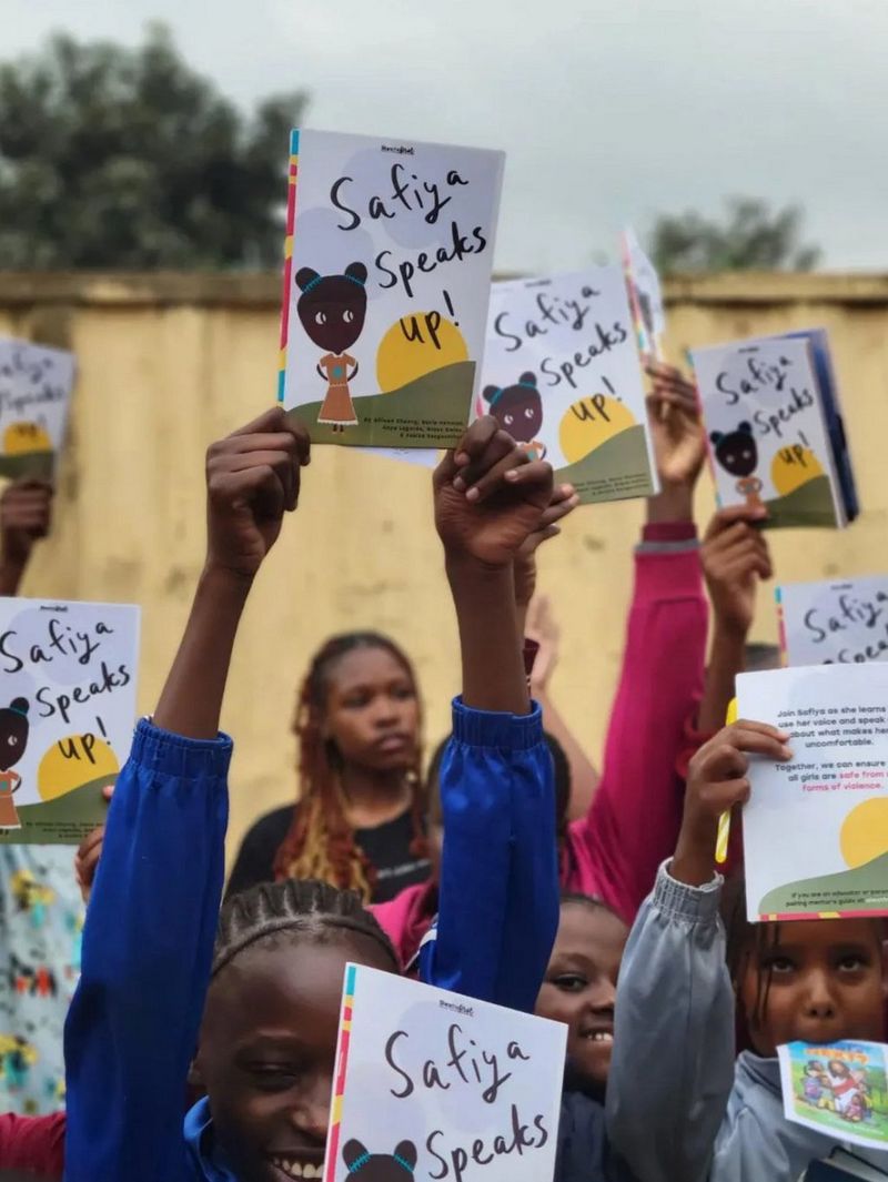 Young people hold up copies of Safiya Speaks Up.