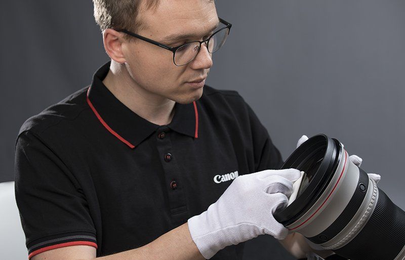 Man cleaning camera