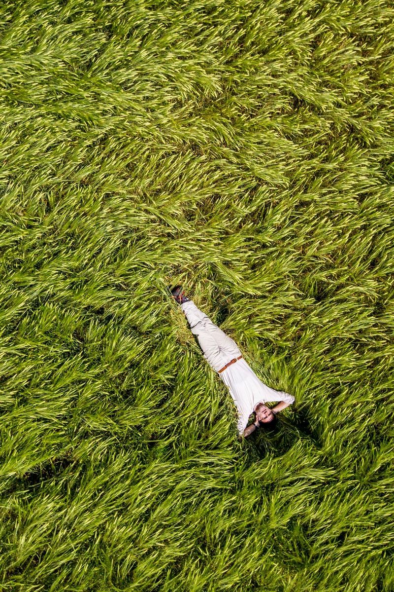 Man lying in field of long grass
