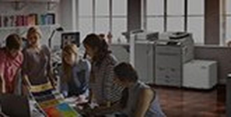 Creative team looking at imagePRESS C165 long sheet banner colour print output