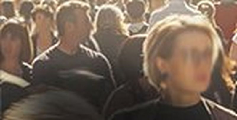 An individual amongst a crowd