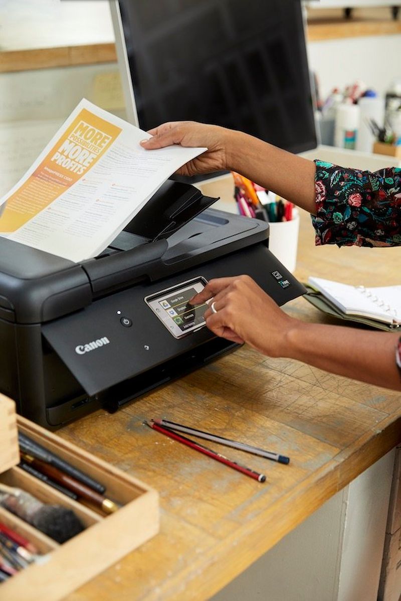 Man, on phone and girl working in background