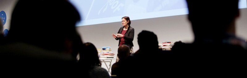 Claudia presents on stage