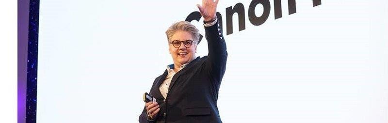 Sara reveals a new product to a group of customers