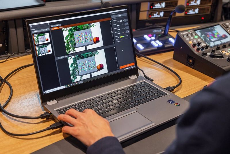 A laptop with Canon's Camera Colour Matching Application on screen.