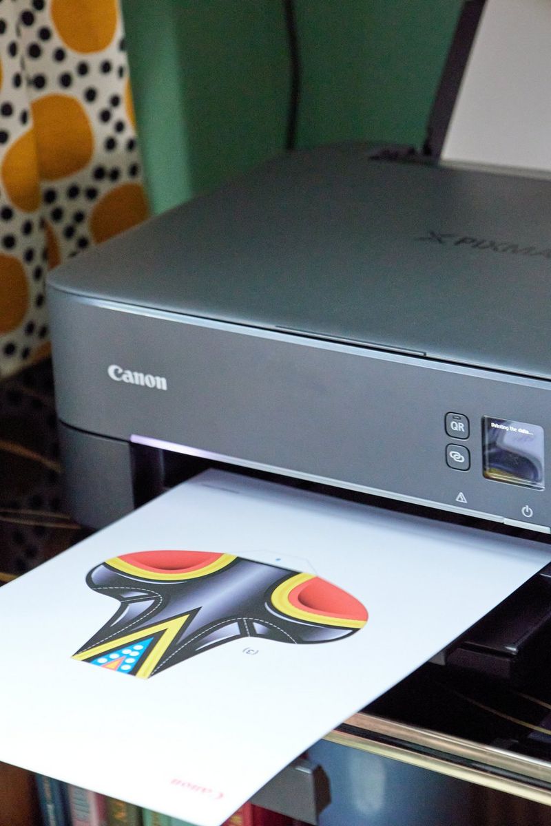 A print of a Canon Creative Park template emerges from a Canon PIXMA print