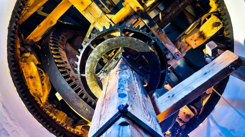 Inside a windmill, looking up at the mechanisms.
