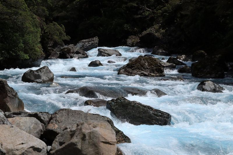 A fast-flowing river strewn with boulders.