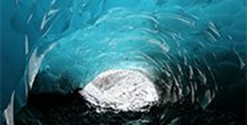 The inside of a bright blue ice cave.