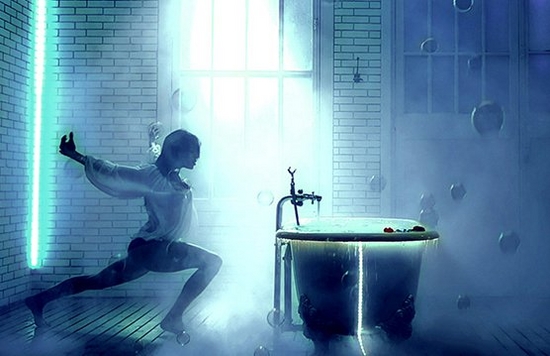 A dancer poses next to a bath tub.