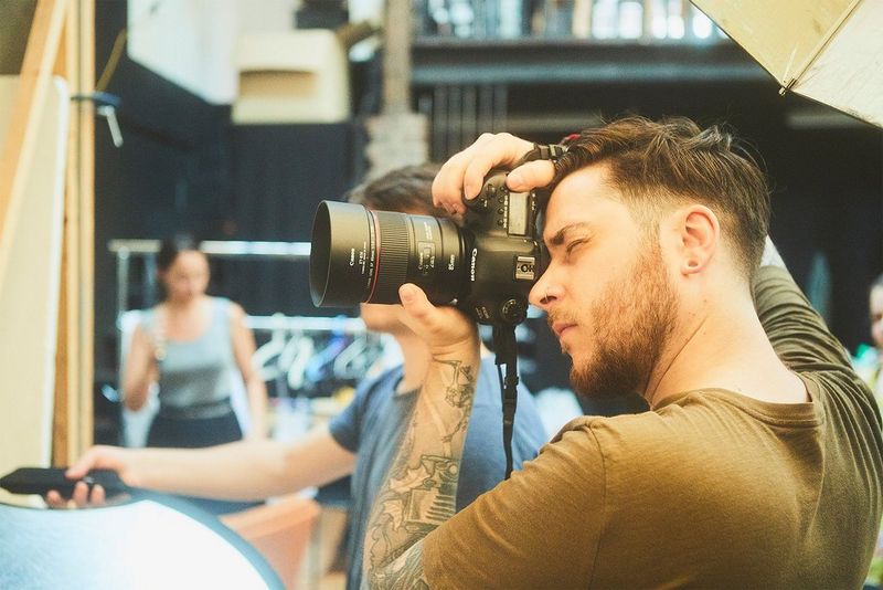 Videographer Quentin Caffier holds a Canon camera. 