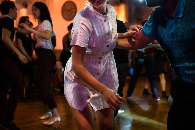 Photographing dancers in low light with the Canon EOS R: A woman in white dances.