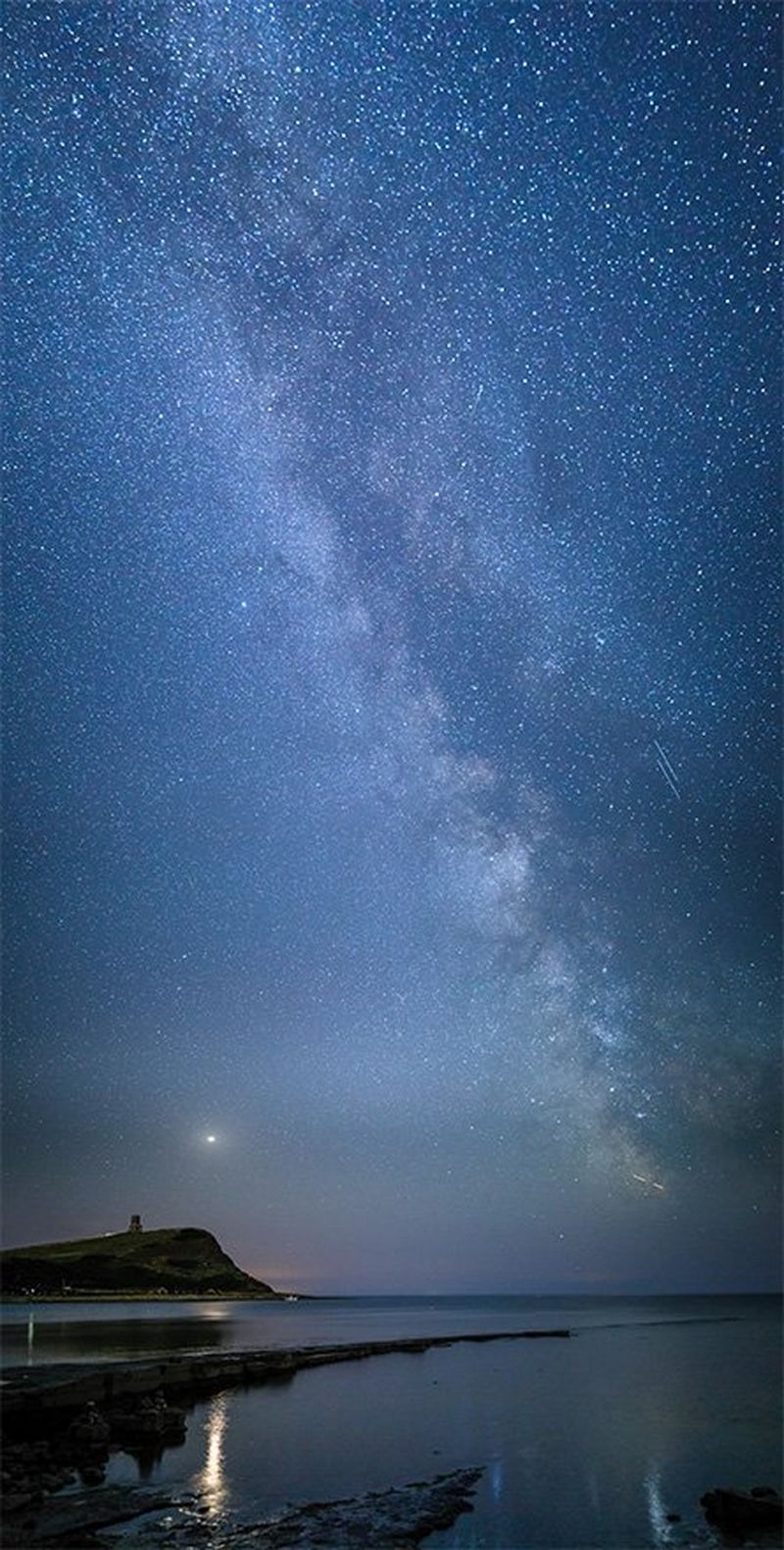 A high-resolution 'stitched' image of the Milky Way over Kimmeridge Bay on the Jurassic Coast of Dorset.