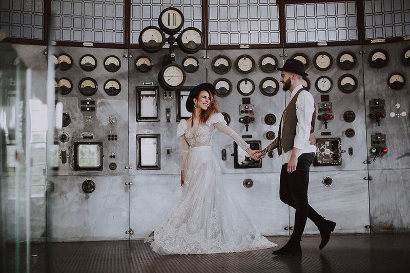 A bride and groom walking and holding hands. Photo by Dasha Starr.