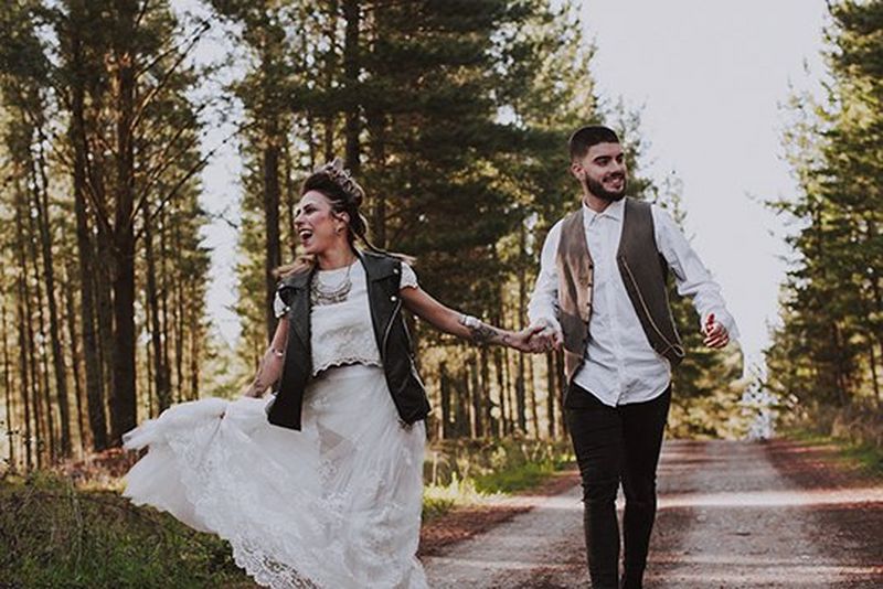 Bride & groom hold hands as they walk down path. Photo by Dasha Starr on Canon EOS 5D Mark III.
