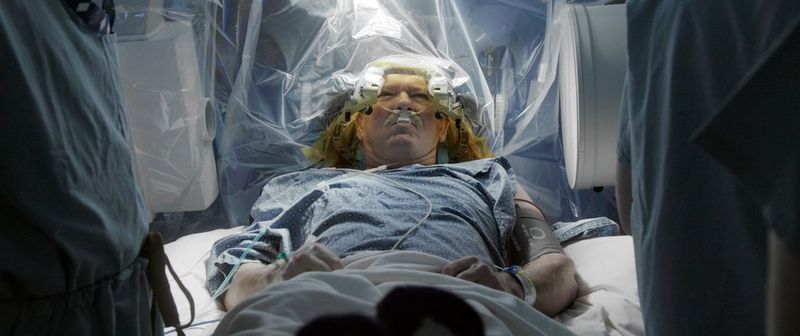 In a still from documentary Hunting for Hedonia, a man is having brain surgery in an operating theatre. 