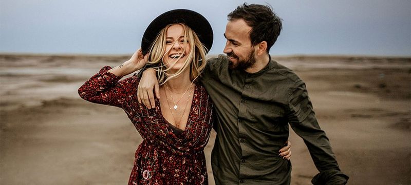 Photographers Julia Blumenthal and Gil Gropengiesser on a beach.