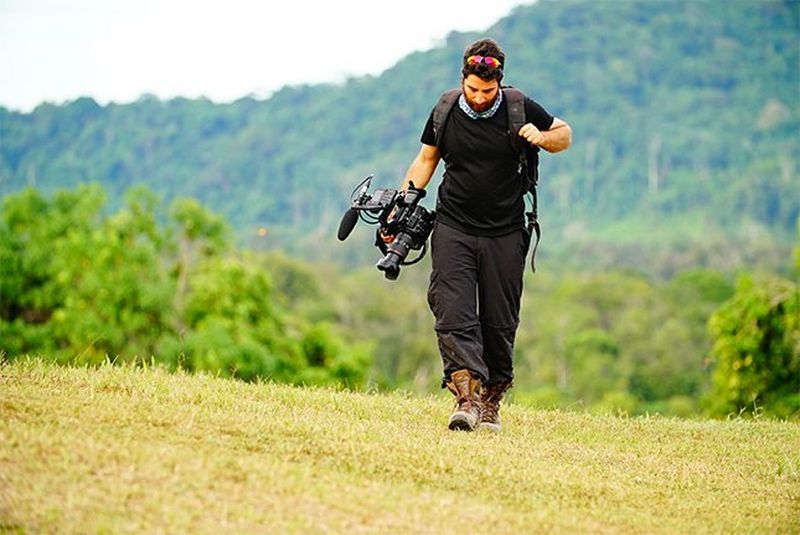 Peiman Zekavat walks outside carrying a Canon EOS C300 Mark II