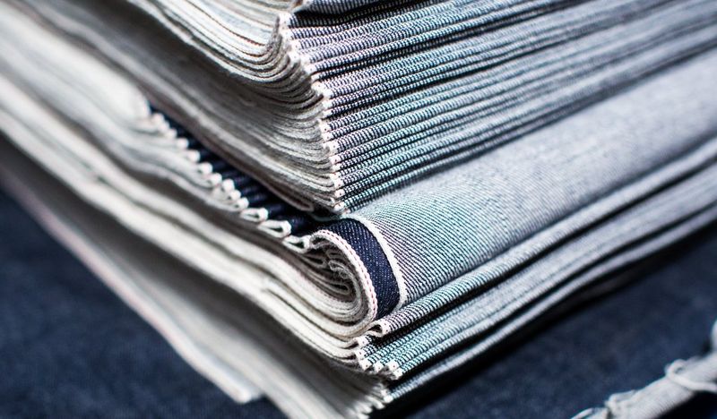 A film still from Made in Japan of a pile of denim cloth.