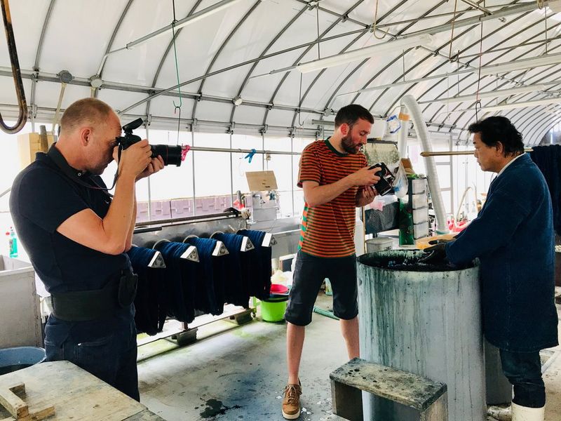 Filmmakers Jack Flynn and Nick David photograph an worker in a denim factory with Canon cameras.