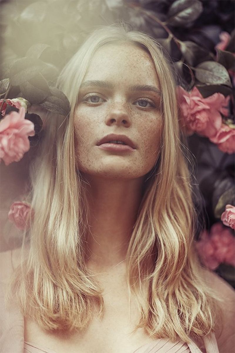 A sunny portrait of a woman surrounded by flowers, taken by Rosie Hardy with a Canon RF 85mm F1.2L USM lens.