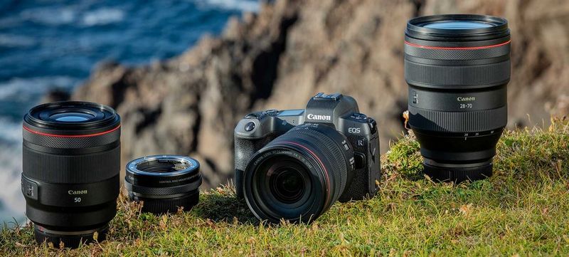 A Canon EOS R with an EF lens on the body plus a 50mm lens, an EF-EOS R Mount Adapter, and an RF 28-70mm F2L USM lens alongside.