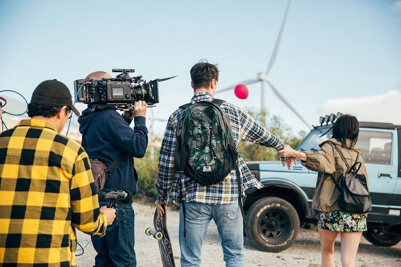 A cinematographer shoulders a Canon EOS C700 FF camera to shoot a short film featuring a young couple in the harsh sunlight of Tenerife.