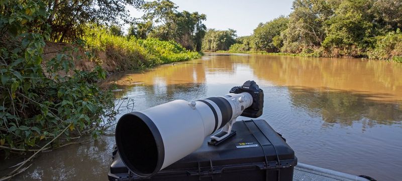 A Canon EOS-1D X Mark III with telephoto lens rests on a camera case in Brazil's Pantanal wetlands.