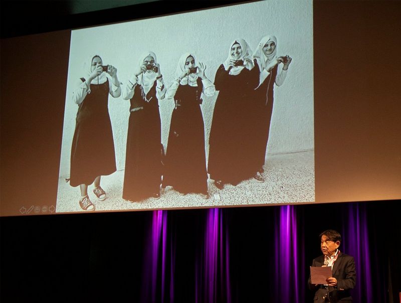 Yuichi Ishizuka, President and CEO of Canon Europe, Middle East and Africa, introduces the panel discussion about the project at the festival of photojournalism Visa pour l&#39;Image 2019.