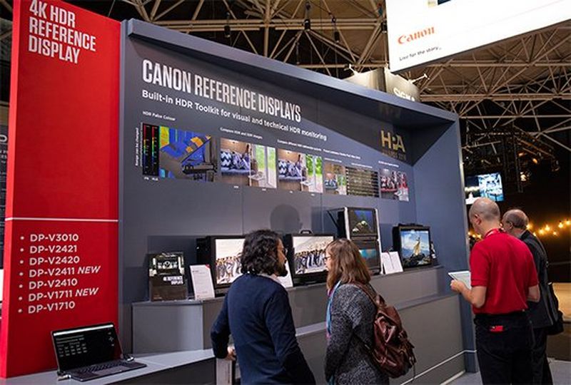 People looking at 4K HDR Canon displays at IBC.