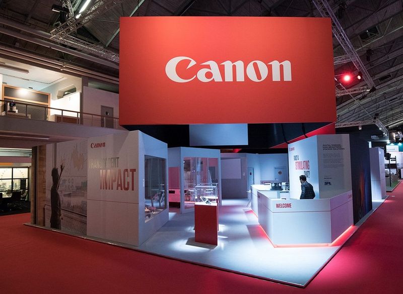 The Canon stand at the ISE trade show, with inspiring photography on displays, projectors and Canon products ready to try, and an expert standing by.