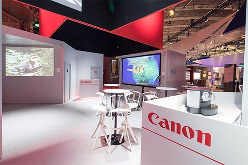 The Canon central area at the ISE trade show, with screens and tables.