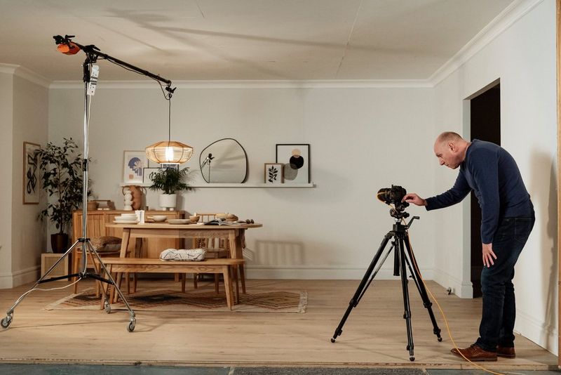 A set made up of various homeware items being photographed by a man with a Canon EOS R6 camera and Canon RF24-70mm F2.8 L IS USM lens.