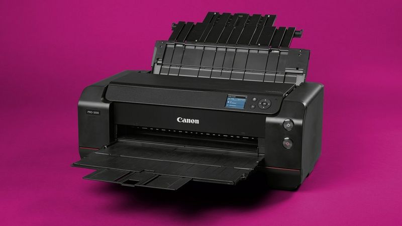 A Canon ImagePROGRAF PRO-1000 printer against a magenta background. 