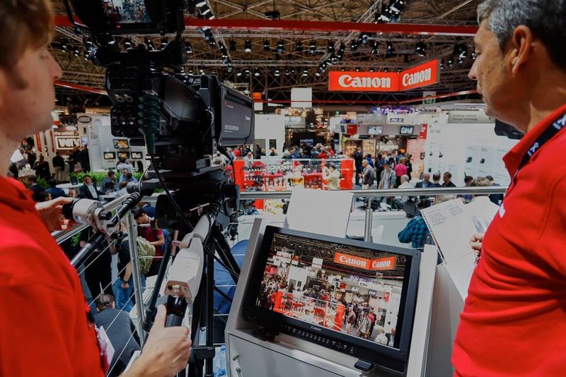 Canon staff overlooking IBC through a broadcast camera’s lens on the Canon stand at the 2017 International Broadcasting Convention (IBC).