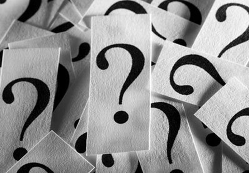 This image has a pile of cards with question marks printed on them.