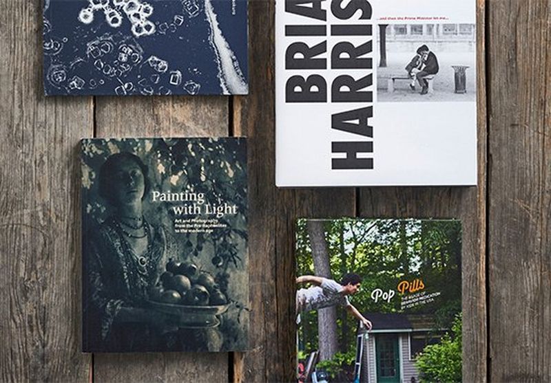 A selection of photography books layed out on a table. 