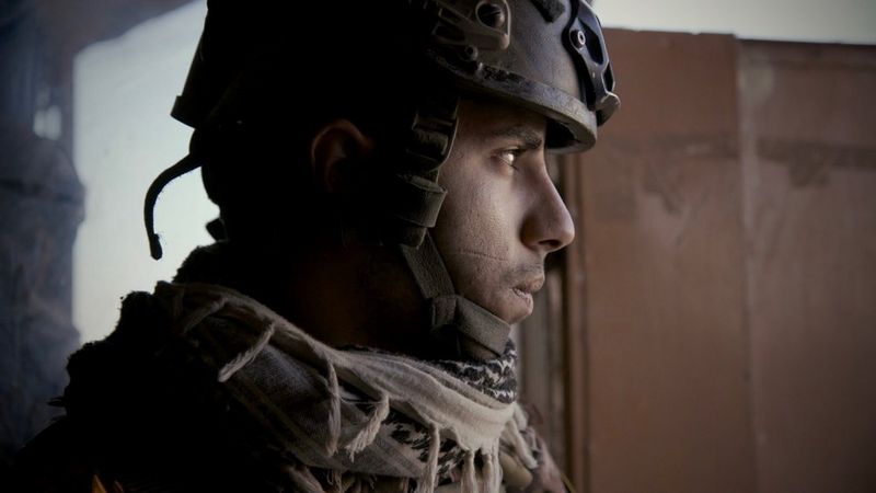 A side-on portrait of an Iraqi Special Operations Forces soldier wearing a helmet. Captured with a Canon EOS C300 Mark II in Mosul, 2016. © Olivier Sarbil