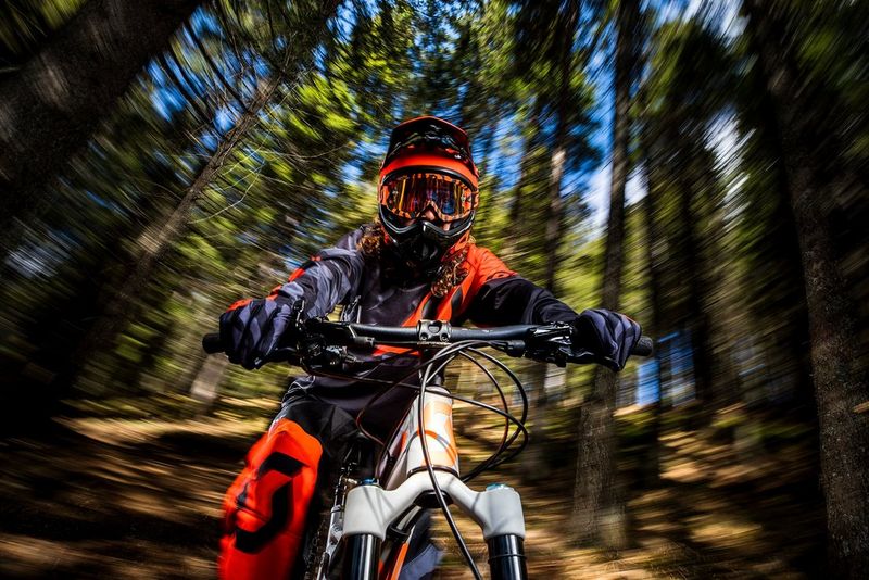 : Samo Vidic’s photo creates the illusion of his paralysed friend cycling at speed down a hill, with the trees swirling and blurring behind him. © Samo Vidic