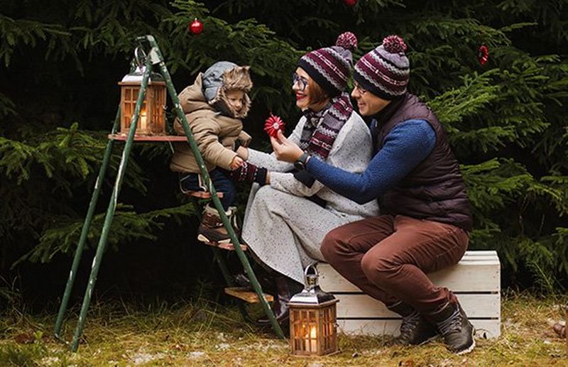 A family sat in front of a Christmas tree.