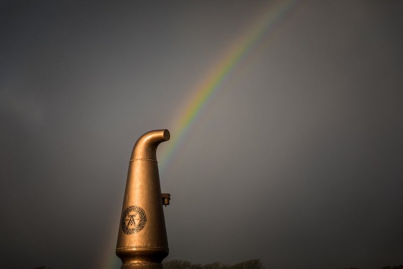 Rainbow above a copper whisky still outside Ardbeg Distillery on Islay captured by Clive Booth on the Canon EOS 5D Mark IV.