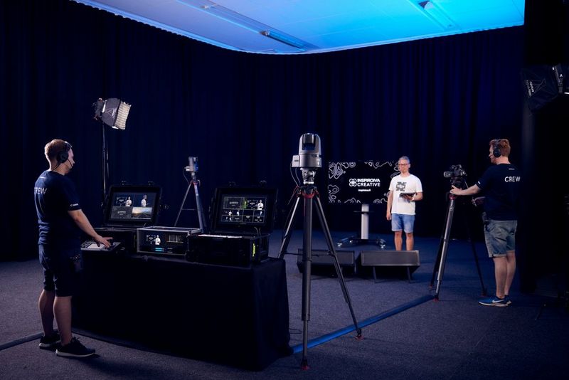 Canon CR-N500 PTZ cameras, a camera operator and a control desk technician recording a presenter in a studio setting.